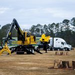 Forestry equipment and semi truck in field