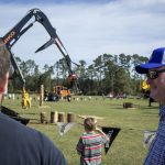 People watching forestry equipment demo