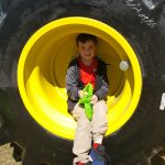 Child sitting on a tire